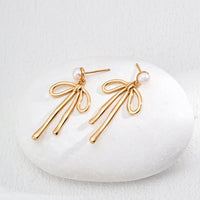 Natural Pearl Bow Earrings in Sterling Silver