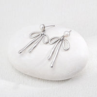 Natural Pearl Bow Earrings in Sterling Silver